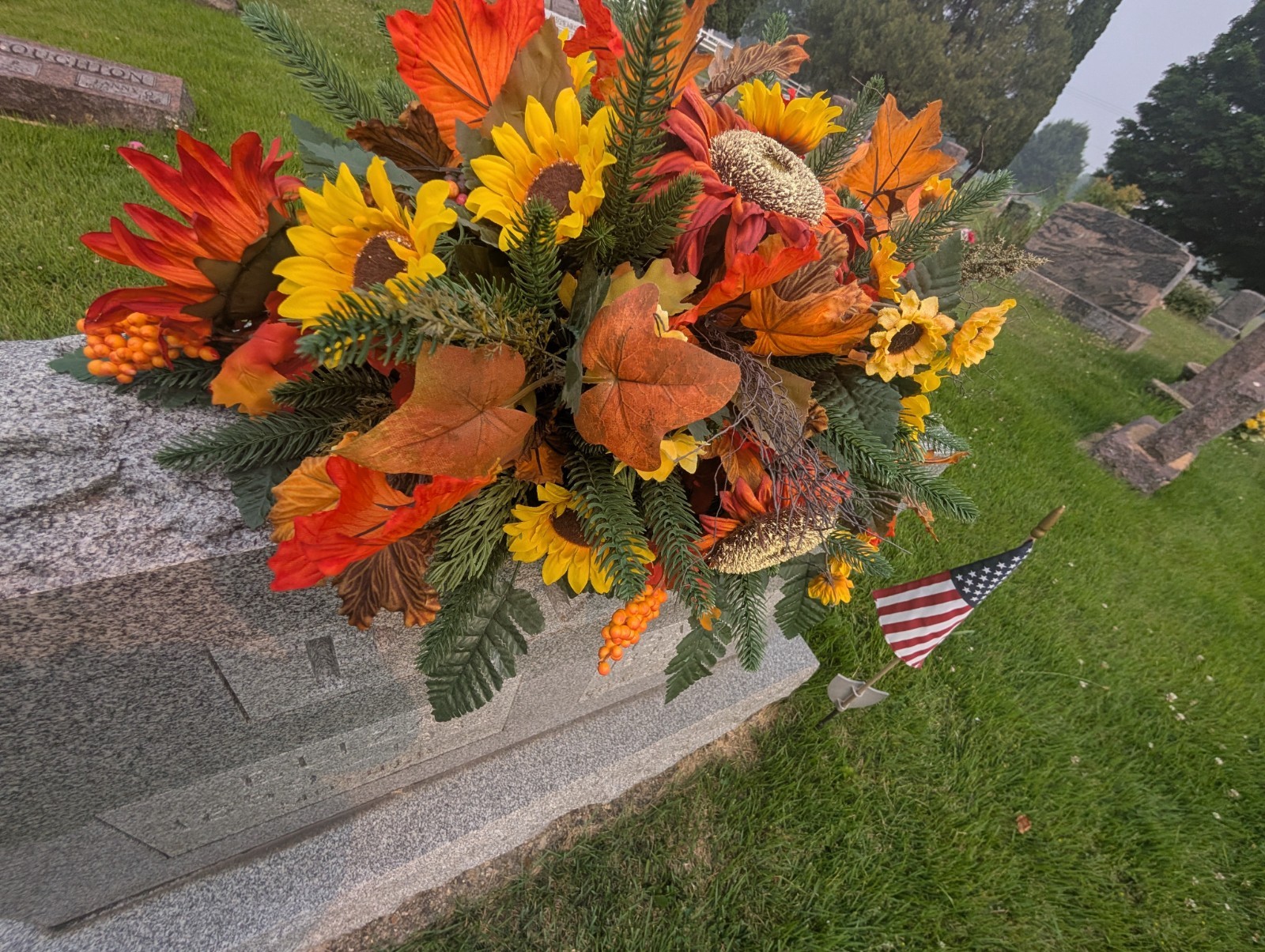 Orange and rust Fall Grave saddle-Sunflower headstone arrangement