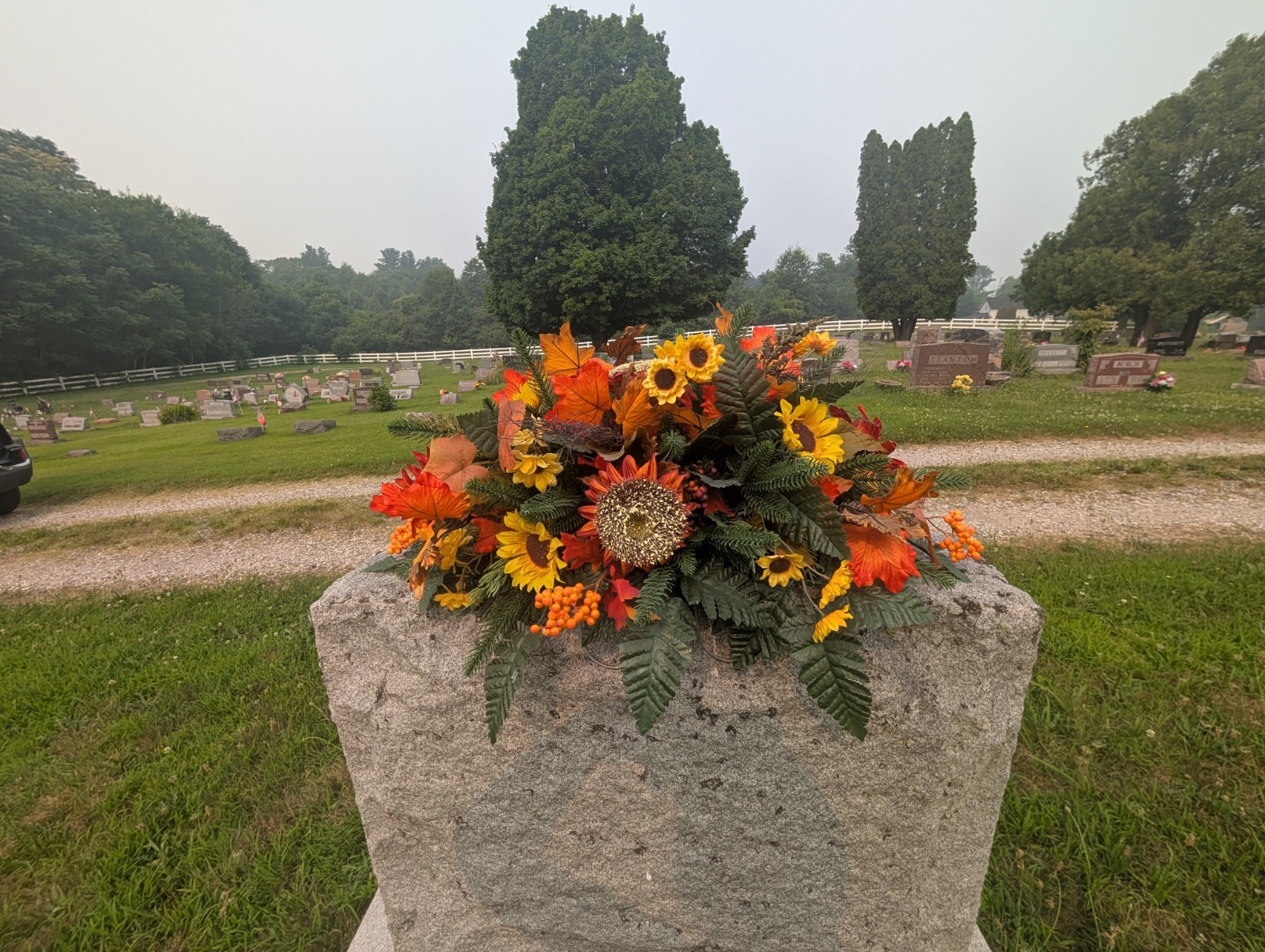 Orange and rust Fall Grave saddle-Sunflower headstone arrangement