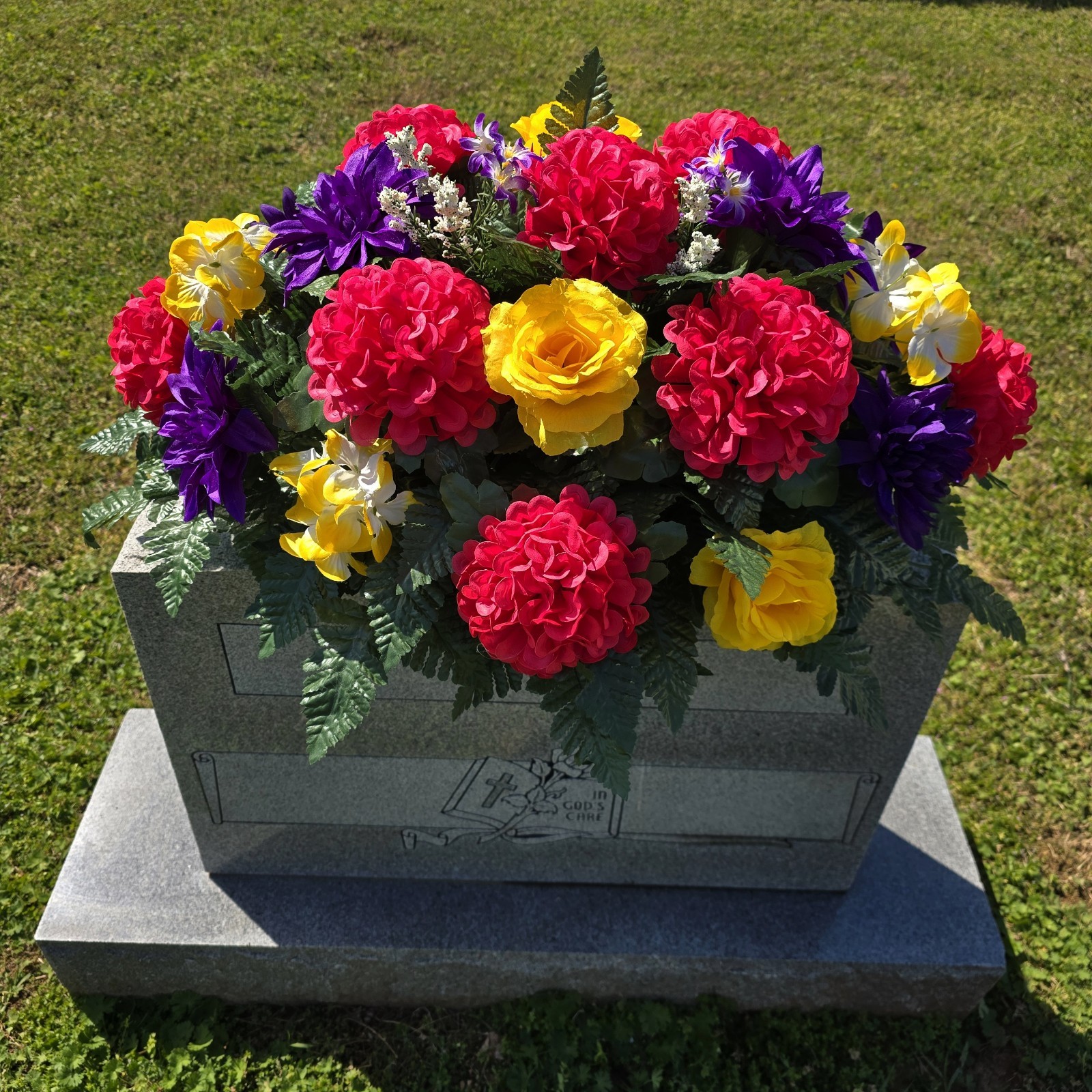 PURPLE,YELLOW, AND PINK CEMETERY HEADSTONE SADDLE WITH CEMETERY FLOWERS