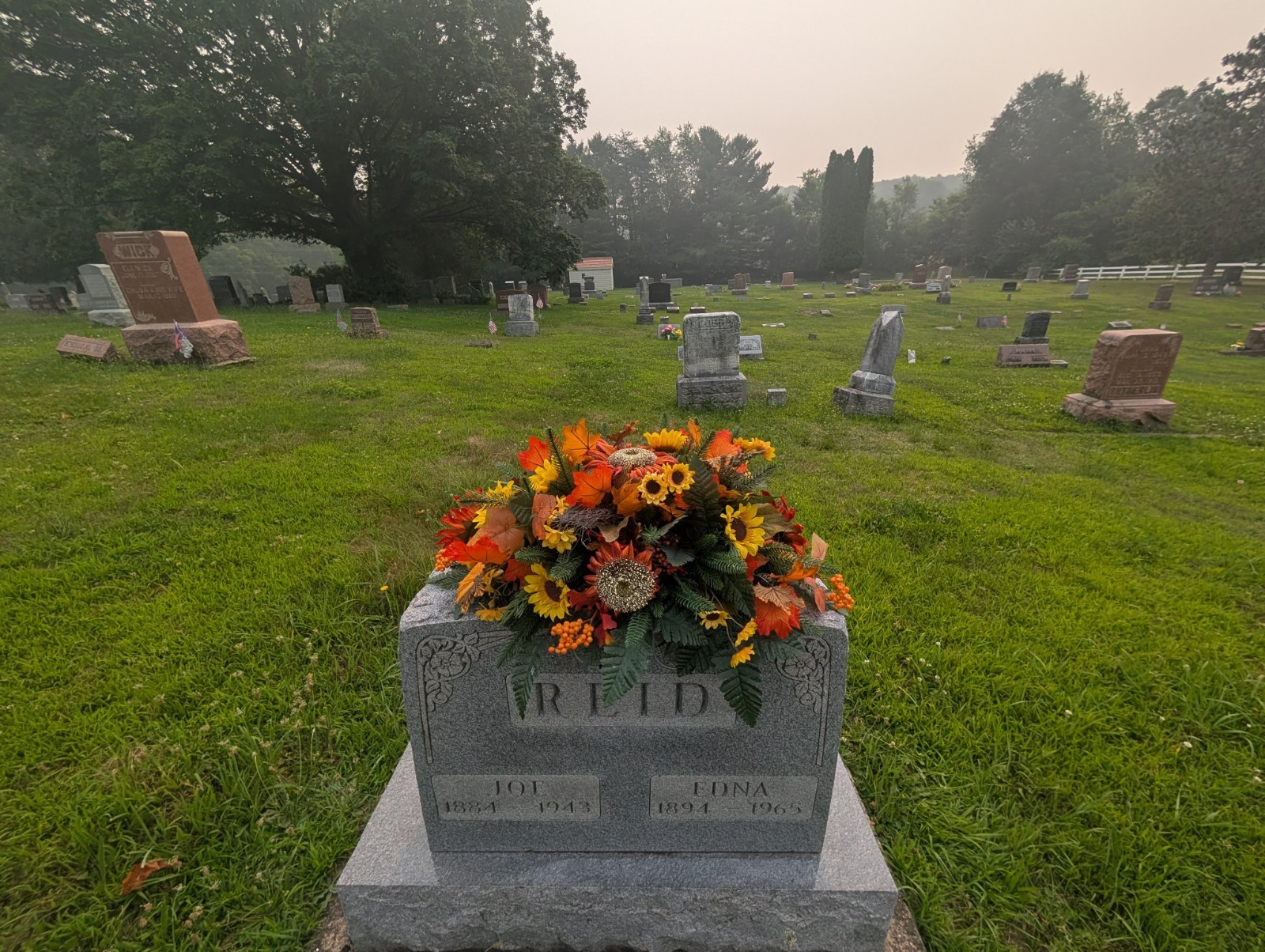Orange and rust Fall Grave saddle-Sunflower headstone arrangement