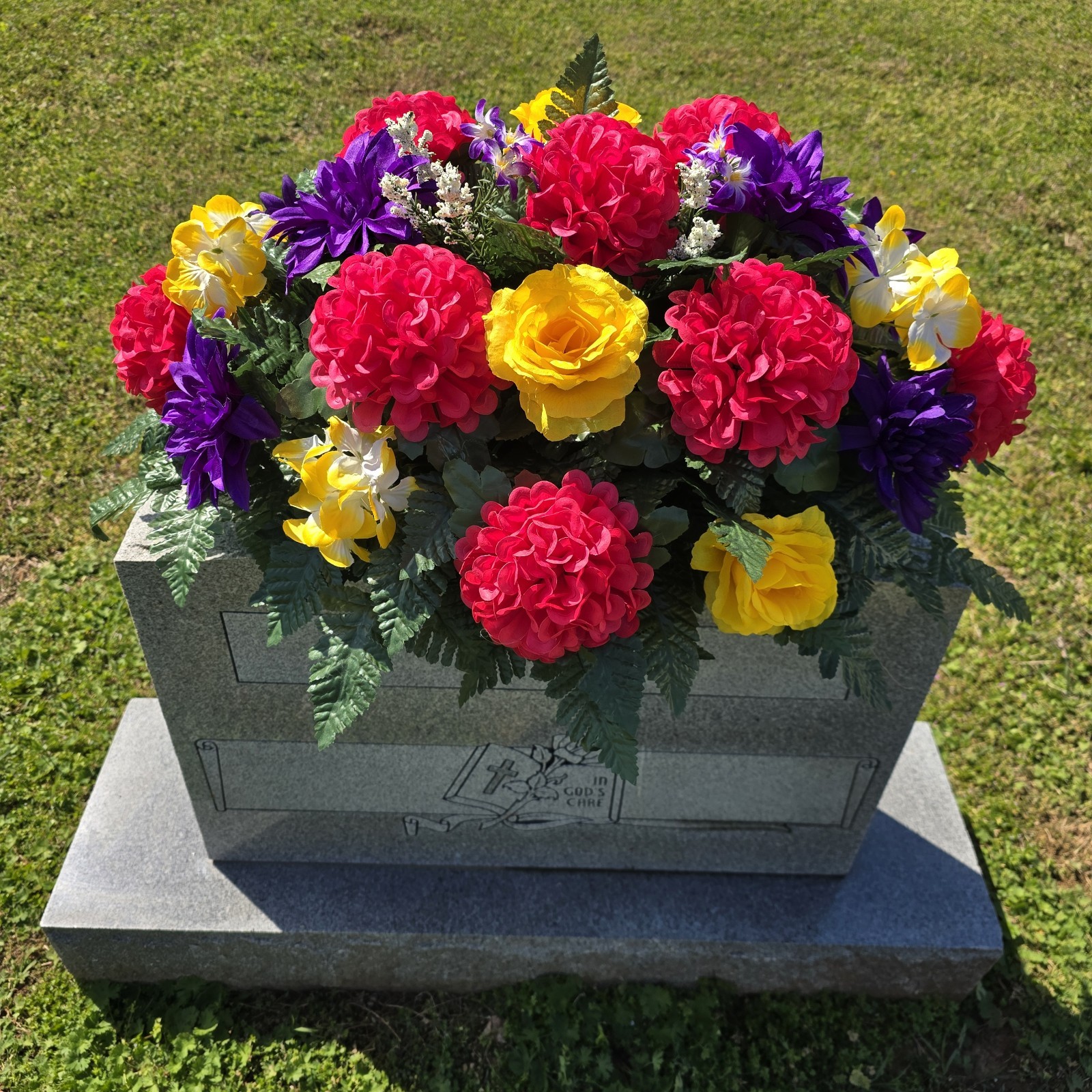 PURPLE,YELLOW, AND PINK CEMETERY HEADSTONE SADDLE WITH CEMETERY FLOWERS