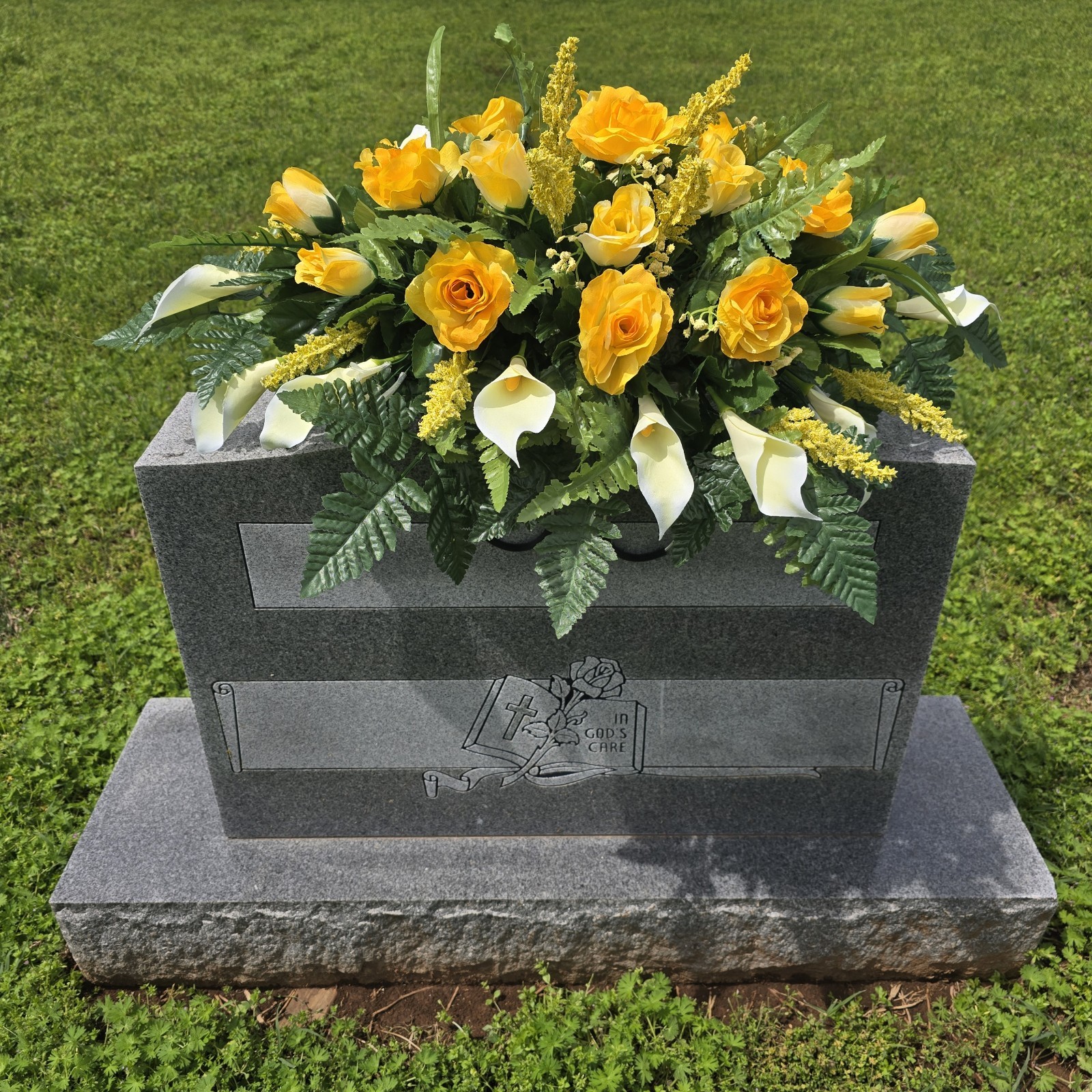 YELLOW HEADSTONE SADDLE WITH YELLOW ROSES AND WHITE CALLA LILY’S FOR CEMETERY