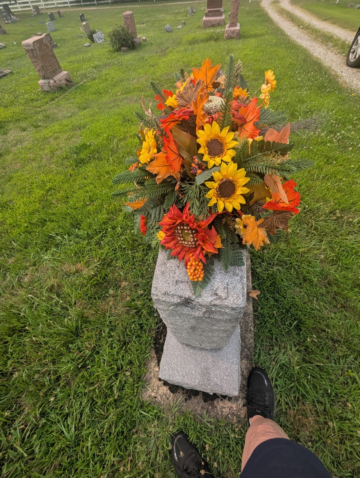 Orange and rust Fall Grave saddle-Sunflower headstone arrangement