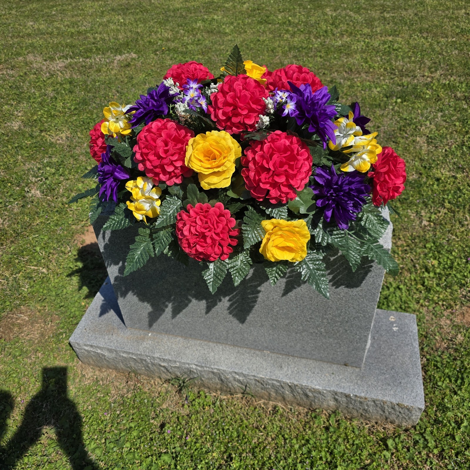 PURPLE,YELLOW, AND PINK CEMETERY HEADSTONE SADDLE WITH CEMETERY FLOWERS
