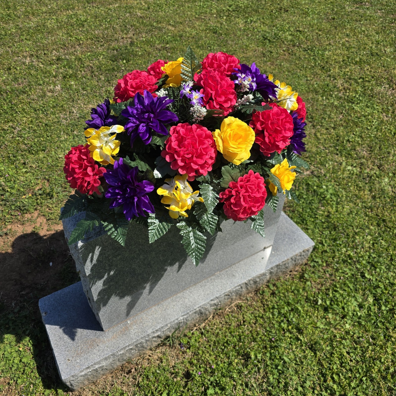 PURPLE,YELLOW, AND PINK CEMETERY HEADSTONE SADDLE WITH CEMETERY FLOWERS
