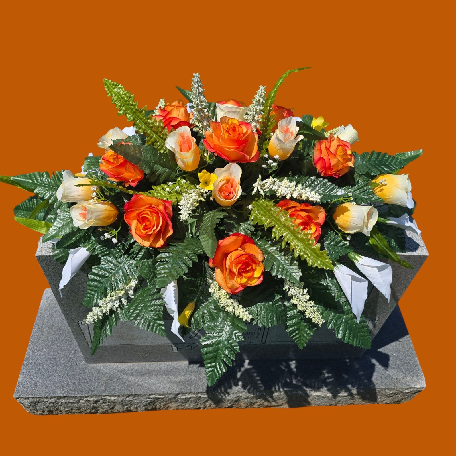 ORANGE AND WHITE HEADSTONE SADDLE WITH ORANGE ROSES & CALLA LILY’S FOR CEMETERY